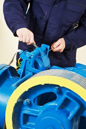 Man repairing elevator motor