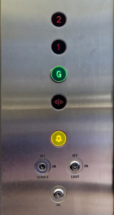 Several stainless steel elevator panel push buttons