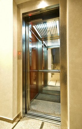 Gold coloured open lift door